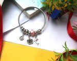 Silver-Tone Twisted Wire Charm Bracelet with Pink Glass Bead, Floral Accents & Dolphin Dangle - Whimsical Ocean Garden Collection