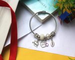Chic Silver-Toned Statement Charm Bangle Bracelet with Love Pendant, Elephant, Shell, and Pearl-Inspired Accents for Modern Ethnic Style - Image 5